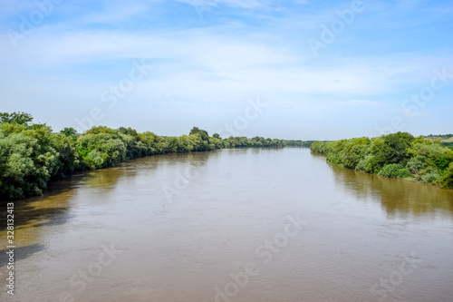 Passing over the bridge over river. The landscape of the river  the surface and the trees of the river s waterplain.