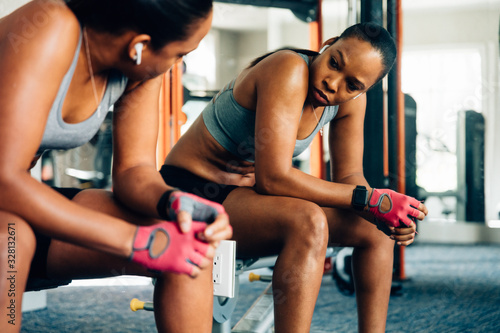 Woman taking a moment to rest in gym