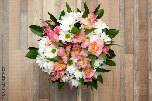 Beautiful bouquet of fresh flowers on a wooden background