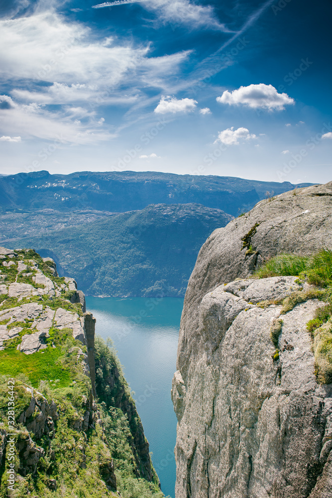 view of the fjord. Two rocks over a cliff. Mountain lake and stone cliffs. Norwegian view from the mountain