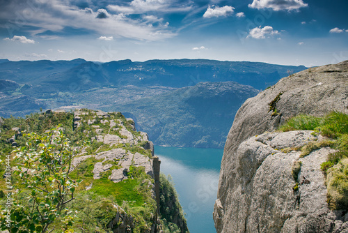 view of the fjord. Two rocks over a cliff. Mountain lake and stone cliffs. Norwegian view from the mountain