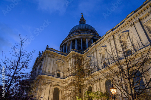 St. Paul's Cathedral in London, UK. Evening view of St Paul's taken from the southeast of the cathedral. Illuminated building, blue sky and clouds