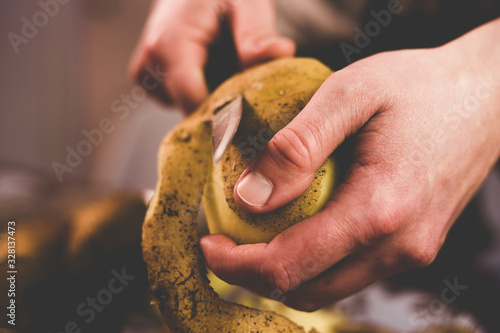 Peeling potatoes with a knife at home