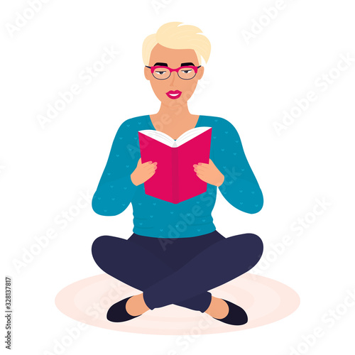 A young girl sitting on the floor and reads a paper book. Student preparing for the exam. Literature fans. Love reading.