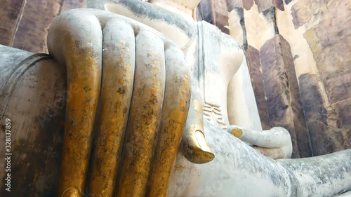 Huge Buddha statue in Si Chum temple at Sukhothai, Thailand, tilt-up