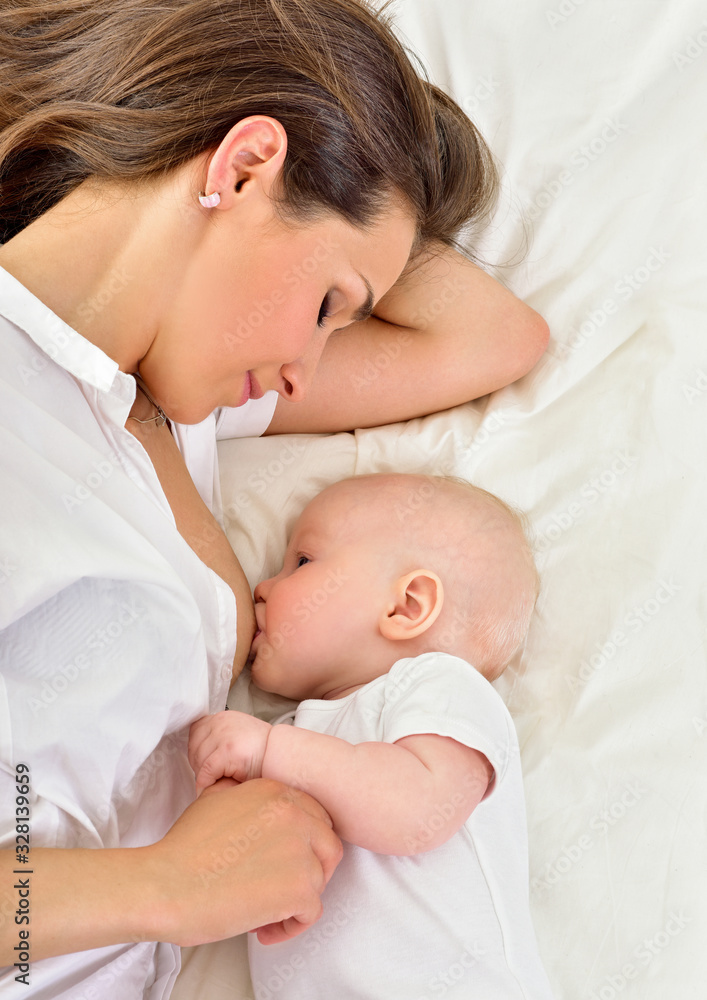 Young mother breastfeeds her baby. Breast-feeding. Young mother breastfeeds her baby. Breast-feeding.