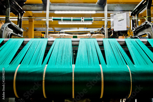 Obraz na płótnie Textile industry with knitting machines in factory - italian - made in Italy w salonie