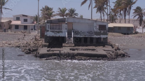 Aerial drone view move of an abandoned house on Colan Beach in Piura Region, Peru photo