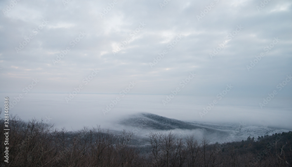 A hill with fog around A hill with fog around