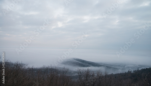A hill with fog around