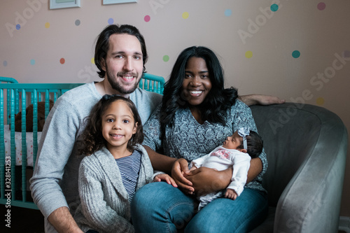 Happy Family portrait with newborn and smiling big sister