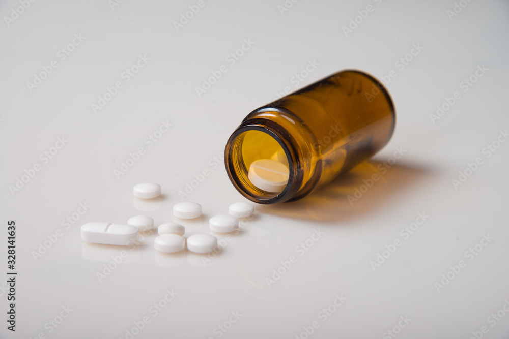 Pharmaceutical concept. Pills with a bottle on a light background. Pharmaceutical concept. Pills with a bottle on a light background.