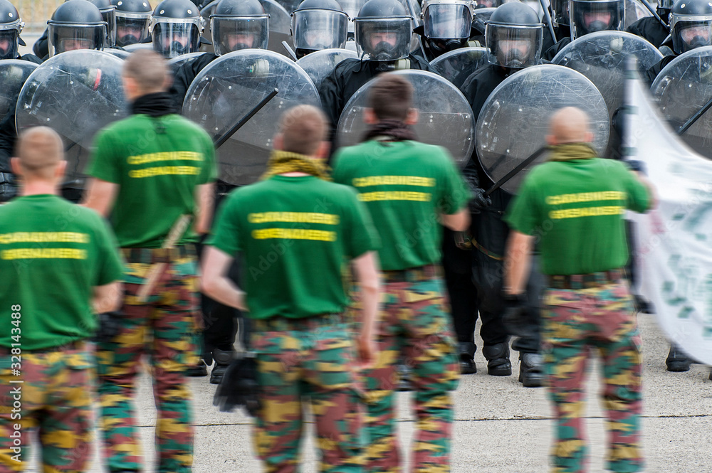 Leopoldsburg, Belgium. May 2011. Demonstration of riot squad forming a protective barrier with riot shields 