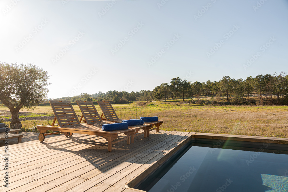 Lounge chairs in modern villa pool