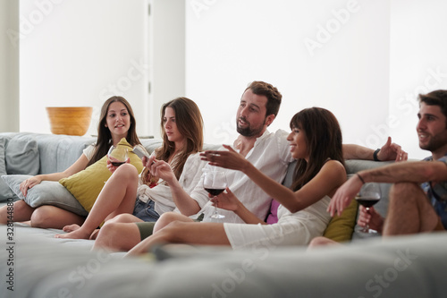 Friends sitting on biggest sofa and having fun.