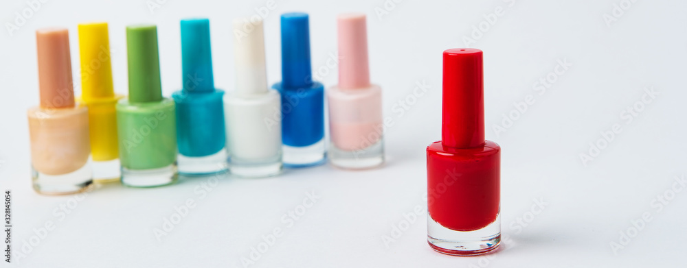 colored nail polishes on a white background colored nail polishes on a white background