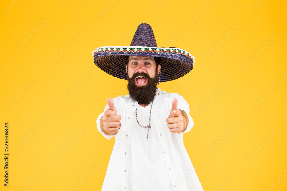 Fest and holiday. Celebrate traditions. hipster looks festive in sombrero.  celebrating fiesta. happy man wear poncho. having fun on mexican party.  sombrero party man. man in mexican sombrero hat Stock Photo