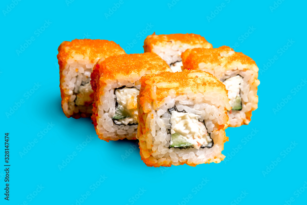 A set of sushi neatly arranged on a blue background A set of sushi neatly arranged on a blue background