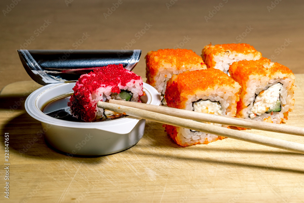 A set of sushi neatly laid out on a wooden surface A set of sushi neatly laid out on a wooden surface