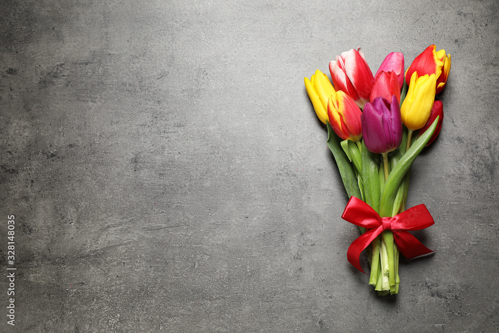 Beautiful spring tulips on grey stone table, top view. Space for text Beautiful spring tulips on grey stone table, top view. Space for text