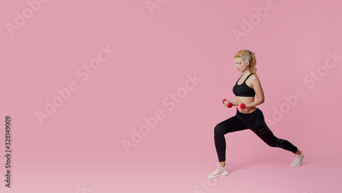 Fitness girl with perfect slim and fit body training muscles with dumbbells on pink background. Sporty woman in sportswear. Sporting goods advertising