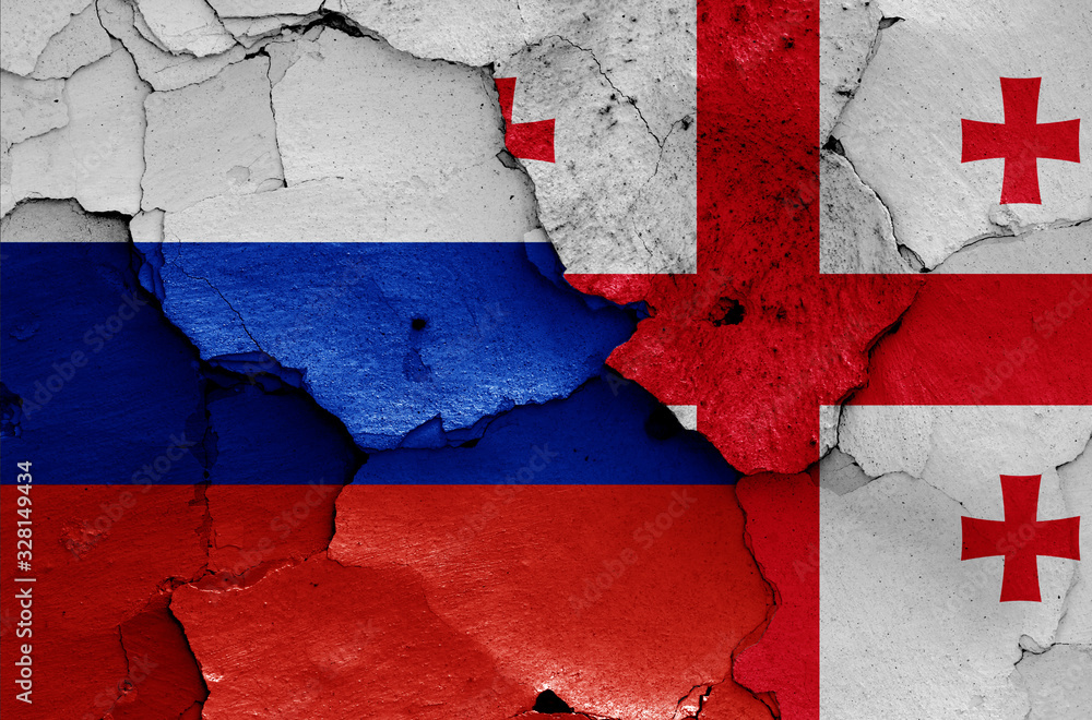 flags of Russia and Georgia painted on cracked wall