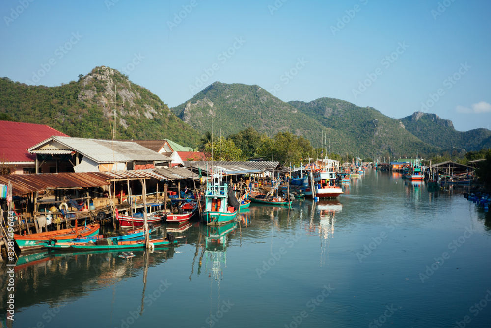 Thai Local Village at the Riverside Surrounded with Mountains Thai Local Village at the Riverside Surrounded with Mountains
