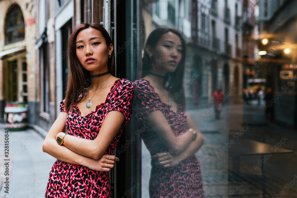 Asian beautiful woman posing and looking at the camara, with her Asian beautiful woman posing and looking at the camara, with her