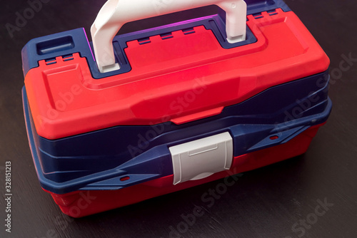 Plastic suitcase box with tool lock    isolated on dark background. industry