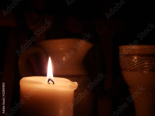 Candle on Left Side with Communion Cup and Pitcher in the backdrop