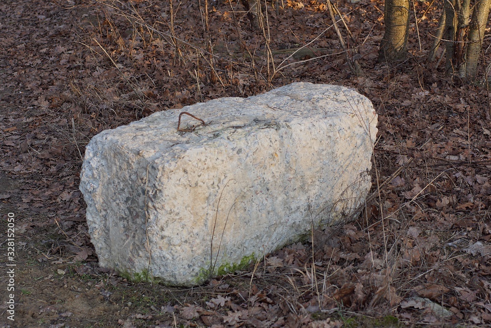one gray long concrete block stands in the dry grass outside one gray long concrete block stands in the dry grass outside