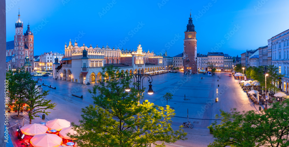 Aerial panorama of Medieval Main market square with Cloth Hall and Town Hall Tower in Old Town of Krakow at night, Poland