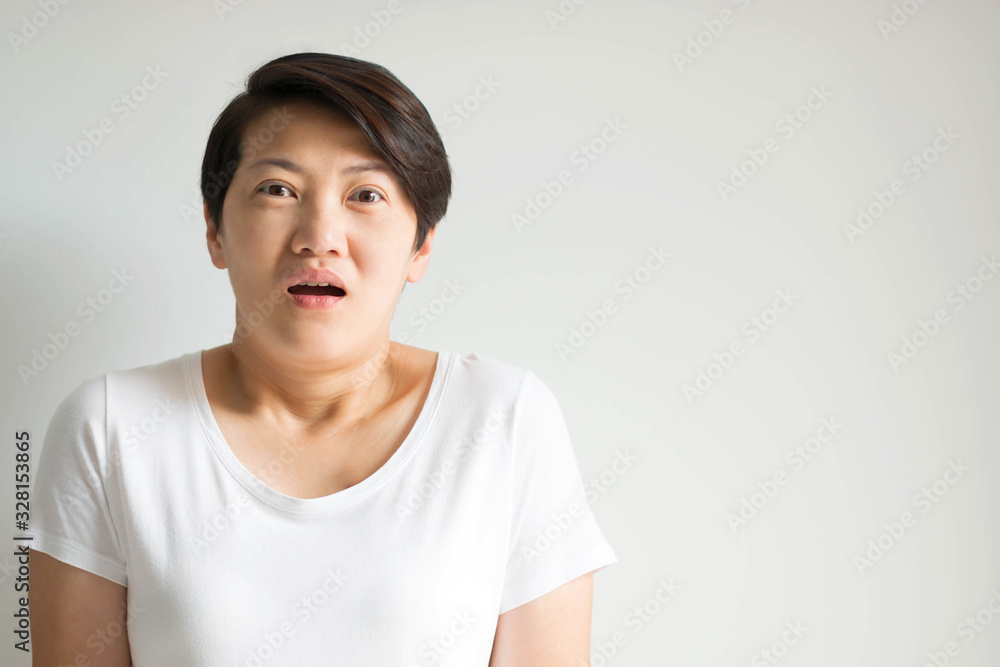 A woman portrait in an expression of stunned, frightened and panic on white background. A woman portrait in an expression of stunned, frightened and panic on white background.
