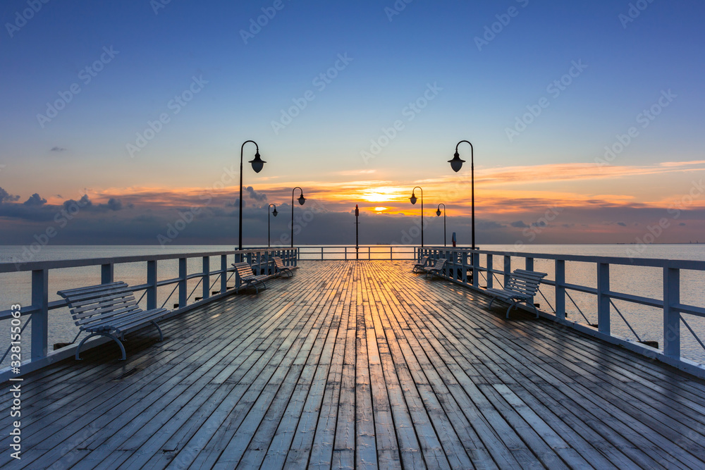 Beautiful landscape with wooden pier in Gdynia Orlowo at sunrise, Poland