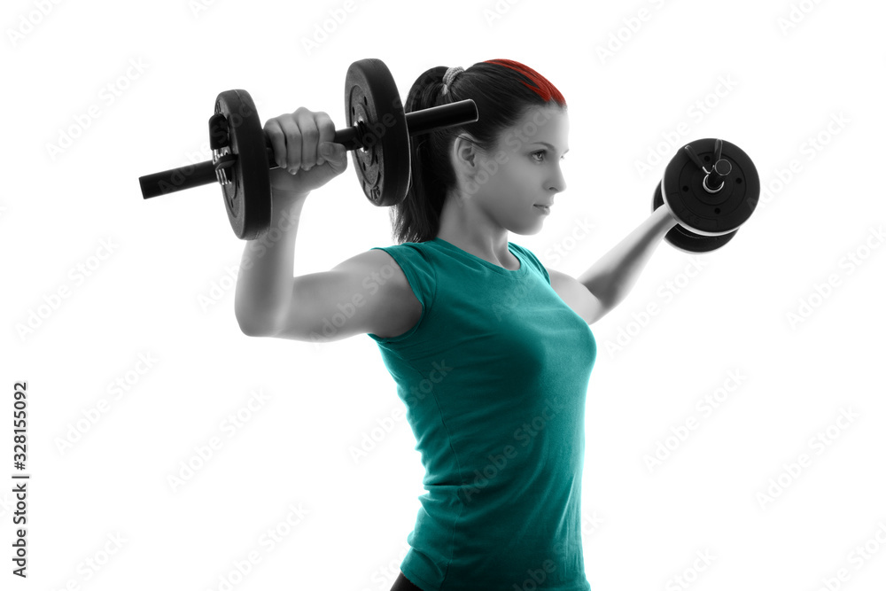 Obraz premium Focused young woman exercising with dumbbells