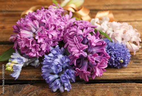 Beautiful spring hyacinth flowers on wooden table, closeup