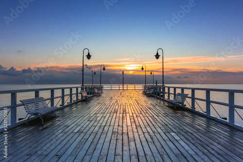 Beautiful landscape with wooden pier in Gdynia Orlowo at sunrise, Poland photo