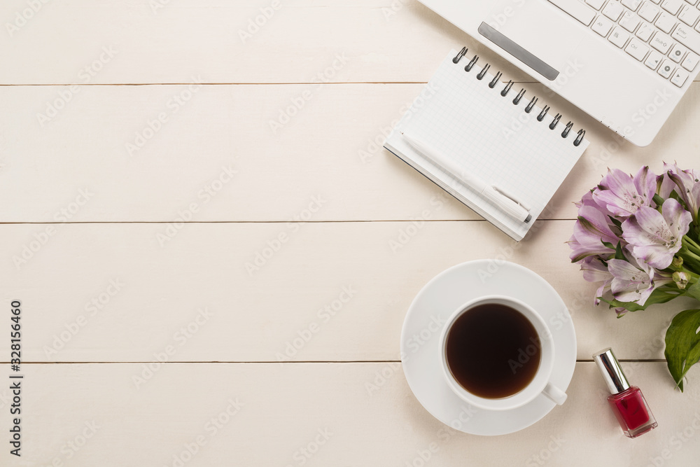 Office table with cup of coffee and flowers Office table with cup of coffee and flowers