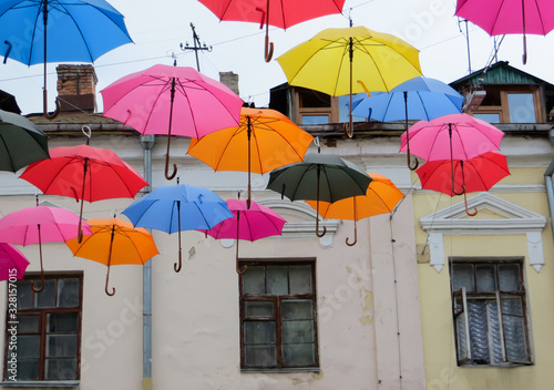 Fototapeta Naklejka Na Ścianę i Meble -  colorful umbrellas on the background of the old house