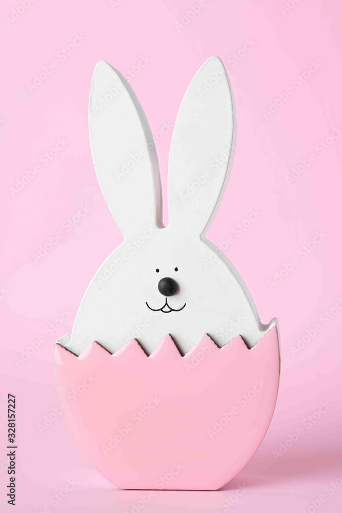 Fototapeta premium Bunny figure as Easter decor on pink background