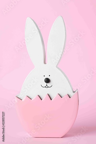 Bunny figure as Easter decor on pink background