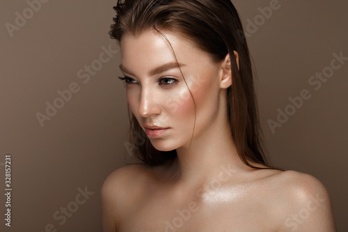 Beautiful young girl with natural nude make-up. Beauty face.