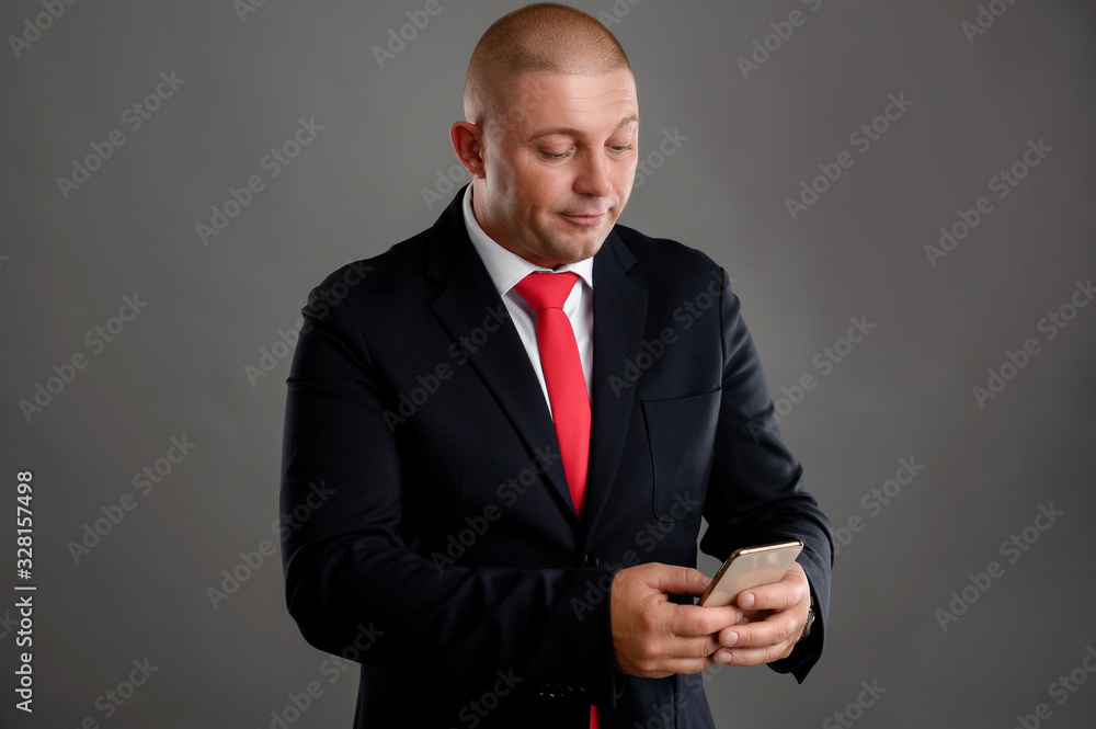 Businessman dressed in black suit using mobile phone, writing text message Businessman dressed in black suit using mobile phone, writing text message