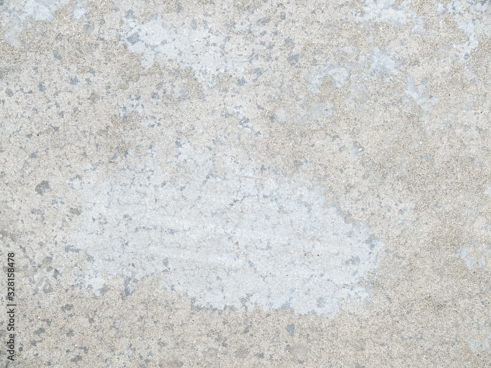 grey concrete floor with many traces of wear and tear due to foot traffic. grey concrete floor with many traces of wear and tear due to foot traffic.