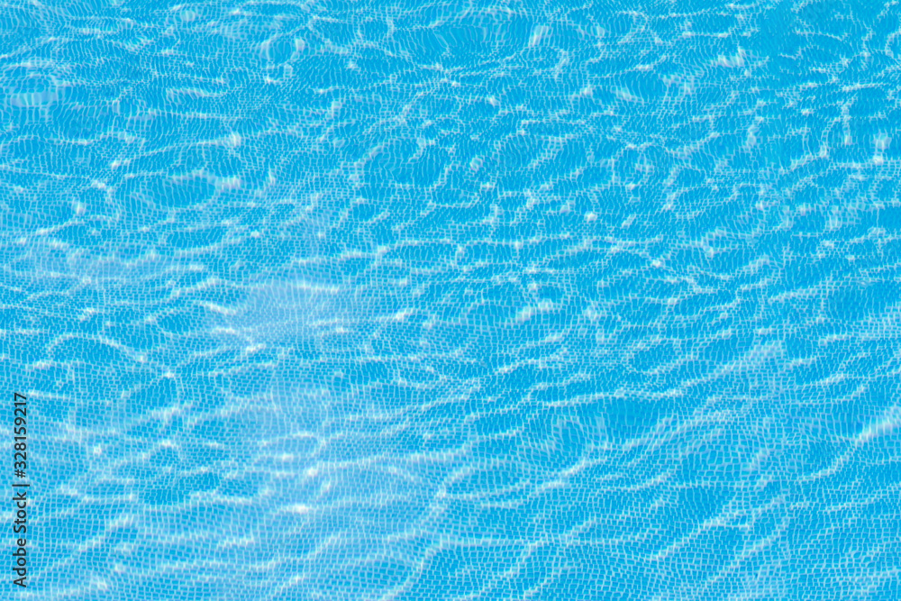 Background with the texture of the water in the pool of blue color that sparkles and sparkles in the sun. Concept texture, background, summer