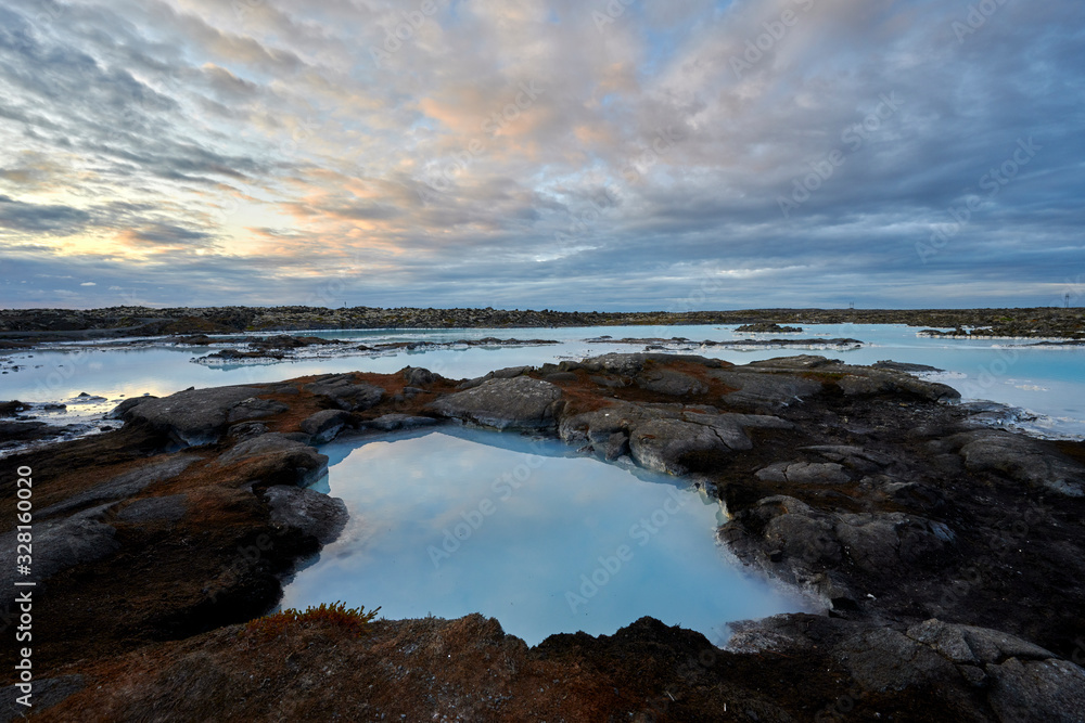 Picturesque scenery of geothermal pool with desert volcanic terrain on island Picturesque scenery of geothermal pool with desert volcanic terrain on island