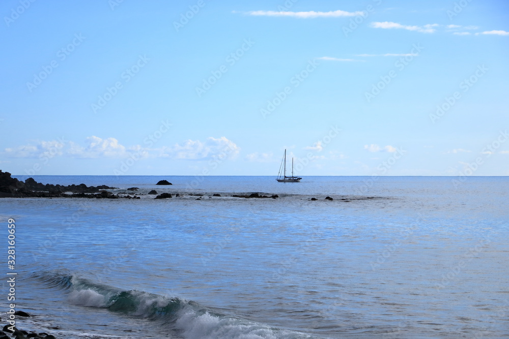 Sailboat in the sea in the evening sunlight, luxury summer adventure