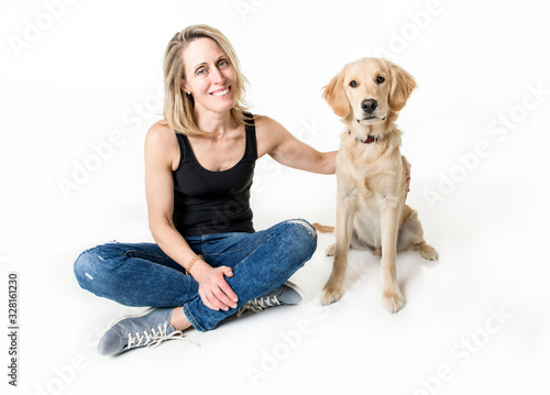 Nice woman and her beautiful Golden Retriever dog over white background