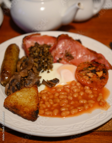 Full Scottish breakfast with bacon, fried egg, beans, tomato, roasted sausage, pudding, hash browns and haggis