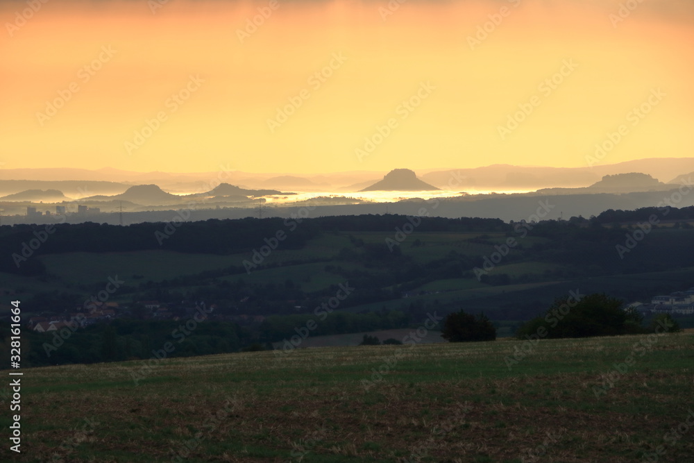 Fototapeta premium Sunrise over the Saxon Switzerland, rocks Lilienstein, fortress Koenigstein